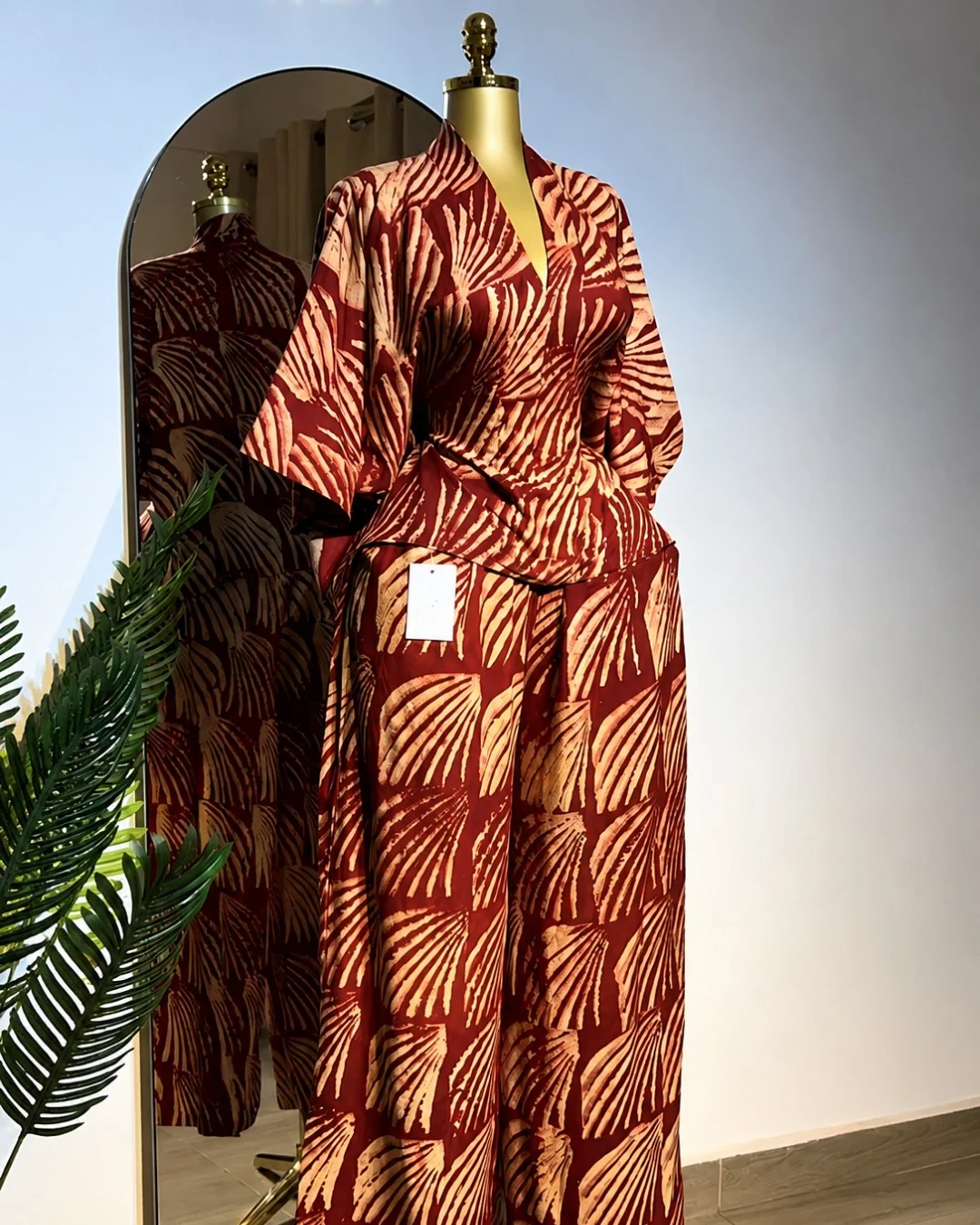 Rust patterned tailored set photographed on a mannequin
