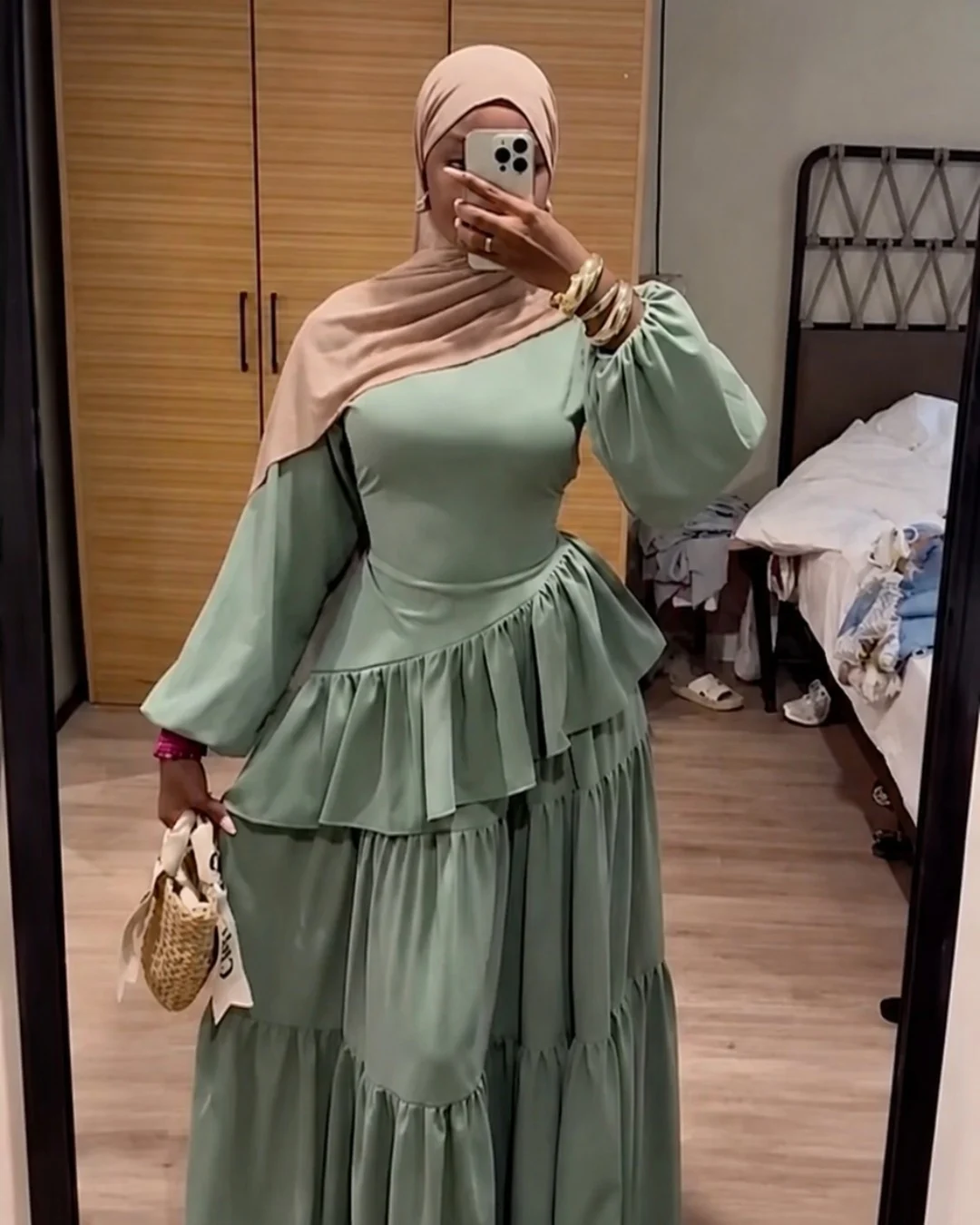 Green modest dress photographed in a bedroom mirror