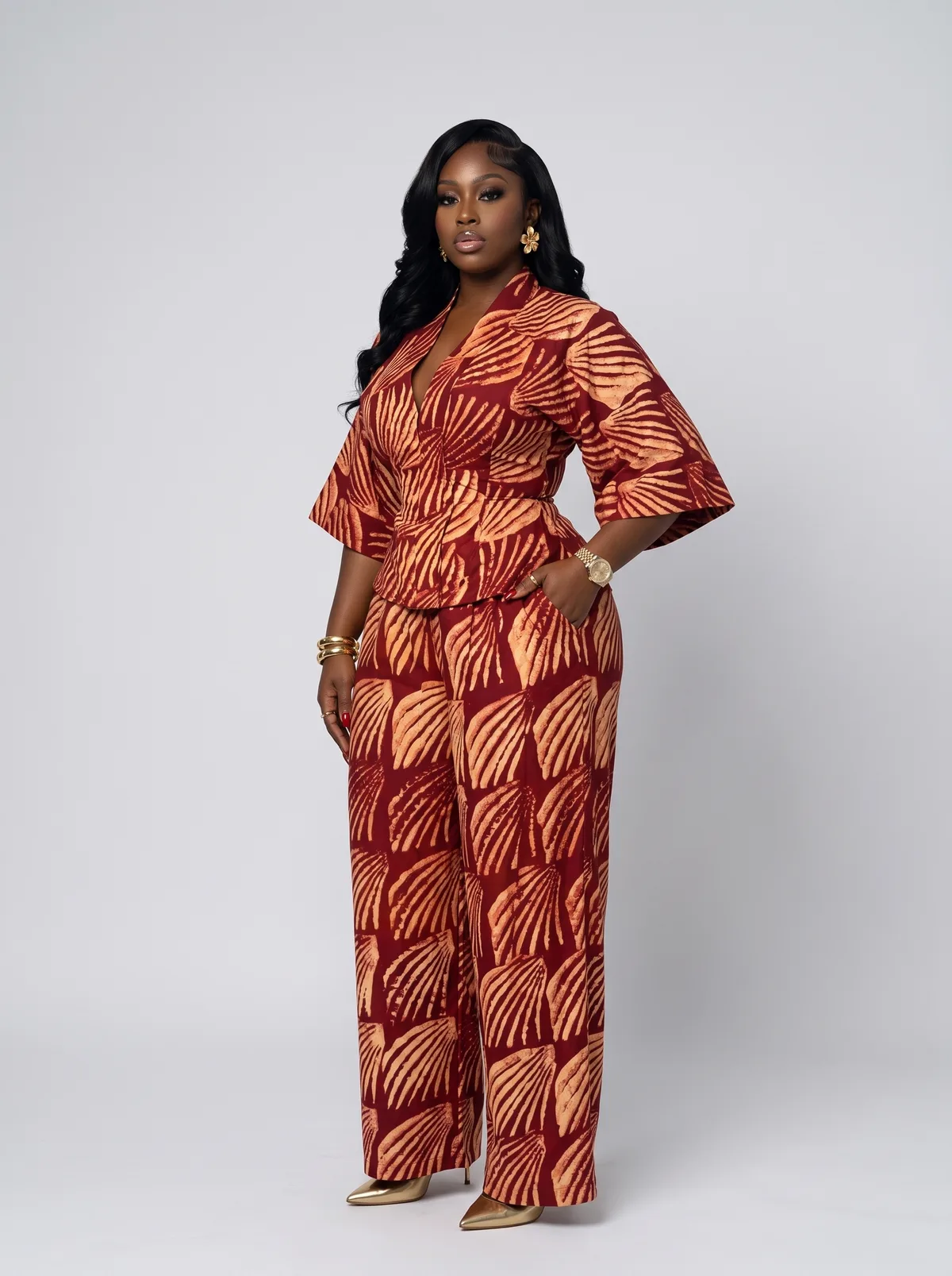 Fictional adult Black woman modelling a rust patterned tailored set in a clean studio