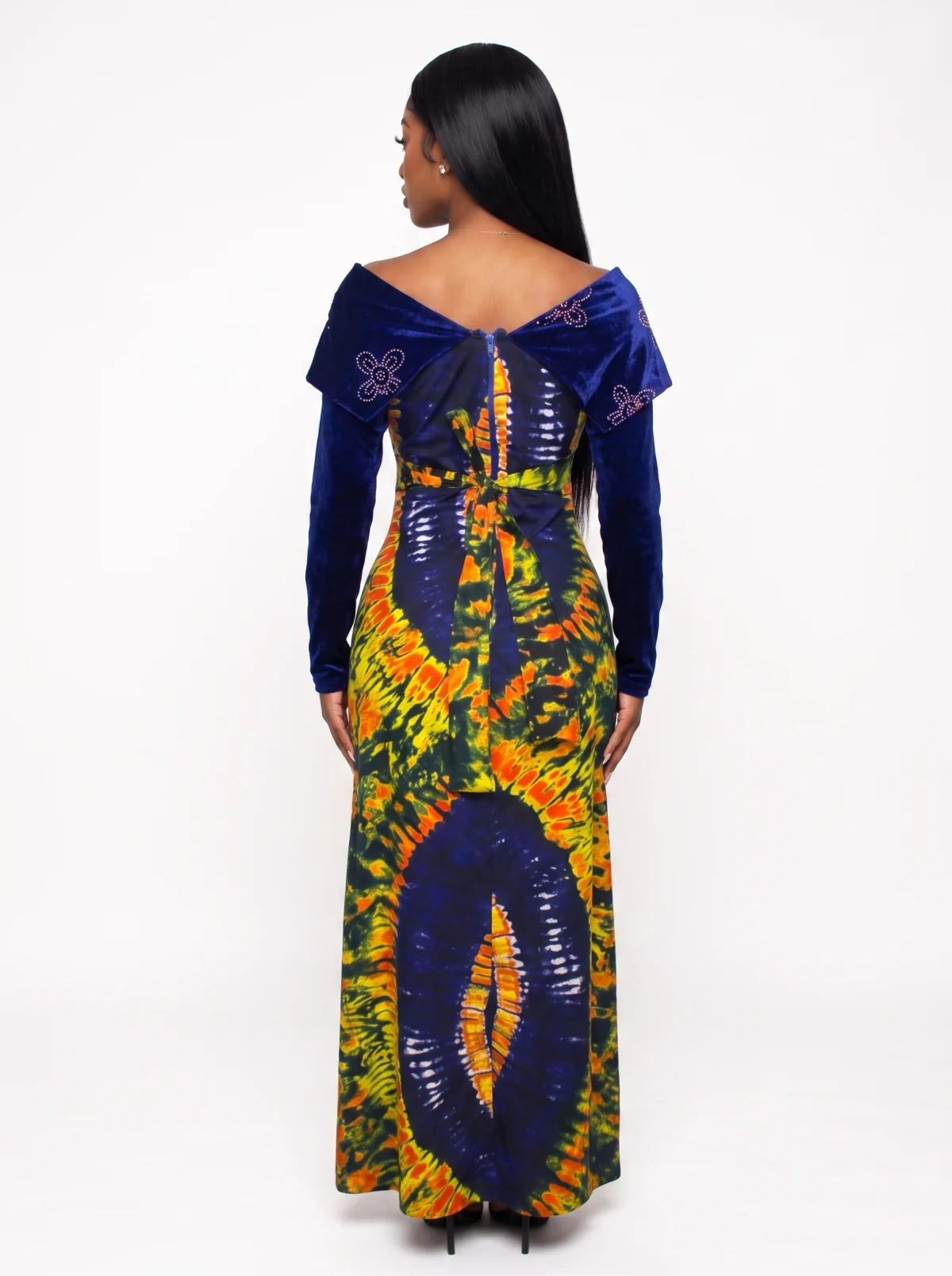 Back view of a fictional Black woman modelling a blue, orange and green floor-length dress